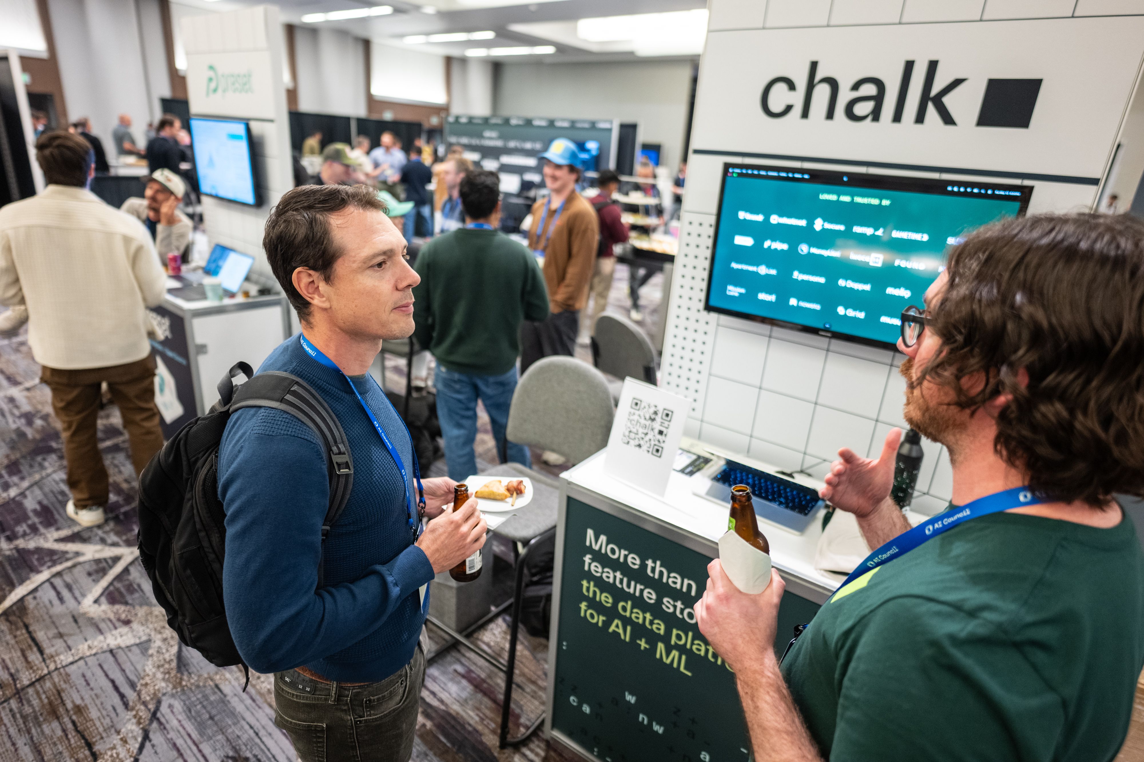 Talking to visitors at Chalk's AI Council booth.